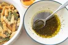Load image into Gallery viewer, Pesto Mix in a bowl combined with olive oil, ready to be poured over cooked pasta - Hidden Valley Crafts